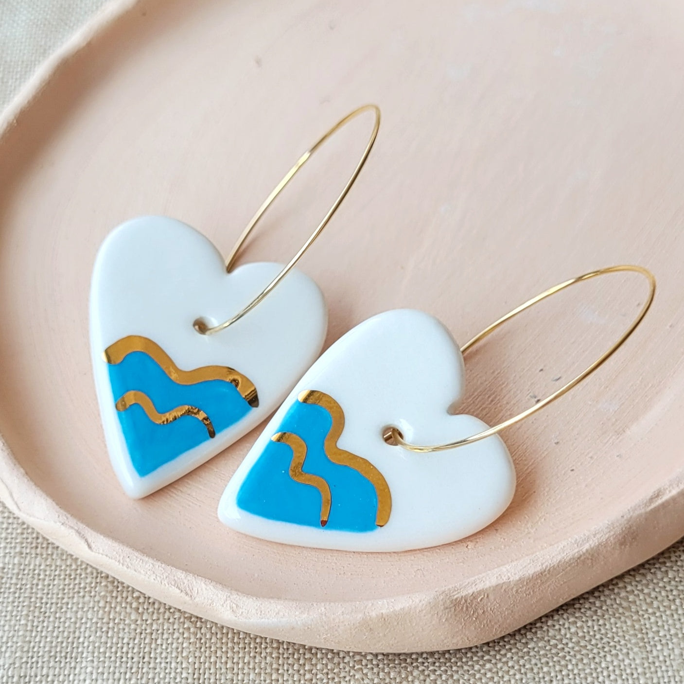 Porcelain dangle earrings with gold "Hearts with waves"