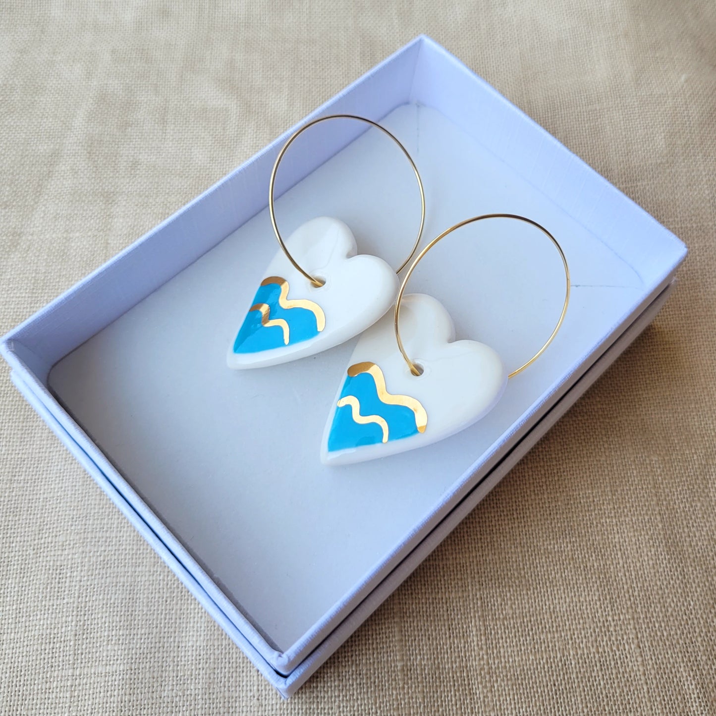 Porcelain dangle earrings with gold "Hearts with waves"