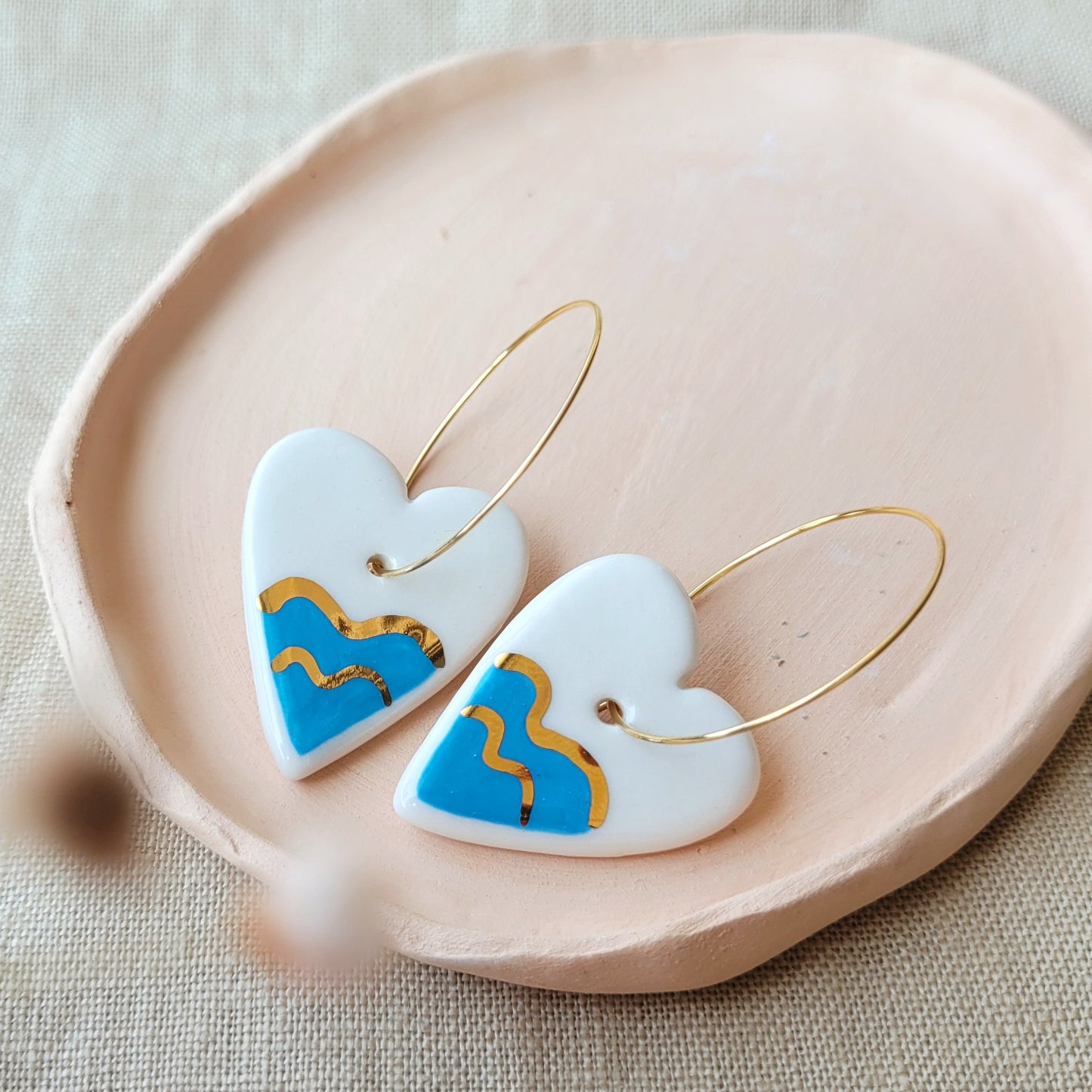 Porcelain dangle earrings with gold "Hearts with waves"