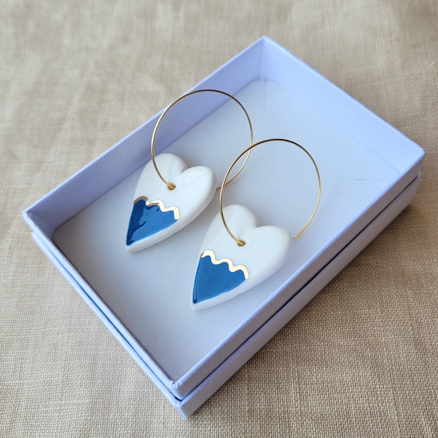 Porcelain dangle earrings with gold "Hearts with dark blue waves"