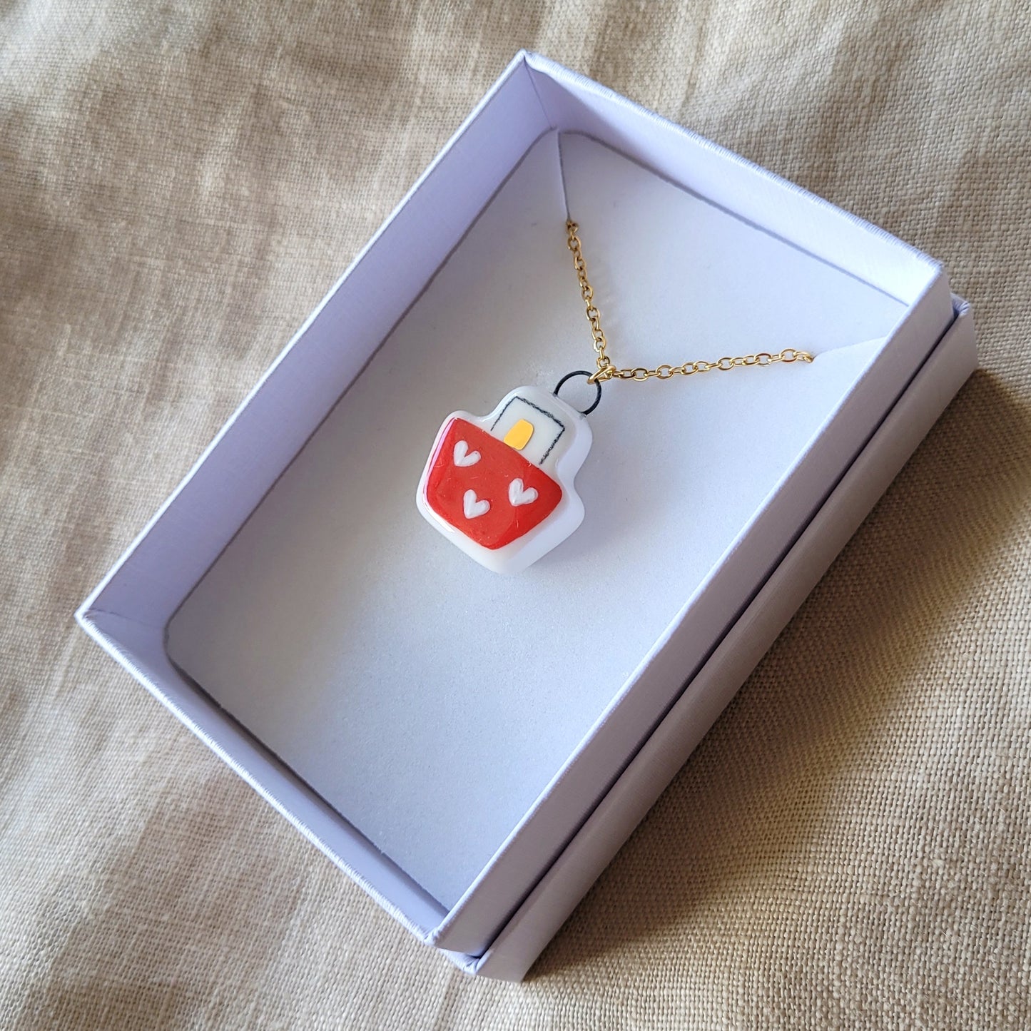 Porcelain necklace with gold "Boat with hearts"