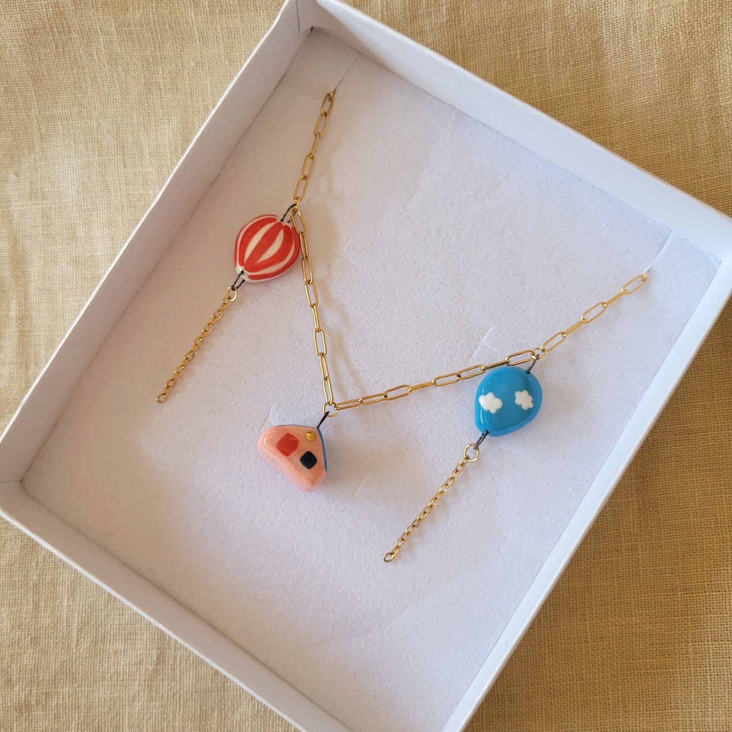 Porcelain necklace with gold "House and two balloons"