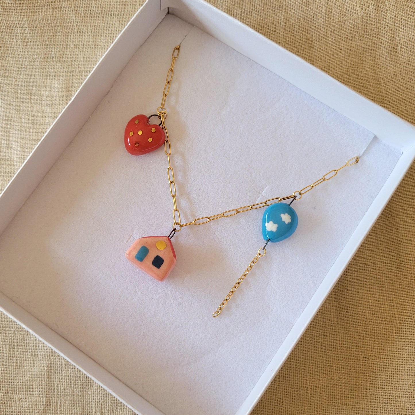 Porcelain necklace with gold "House, heart and balloon"