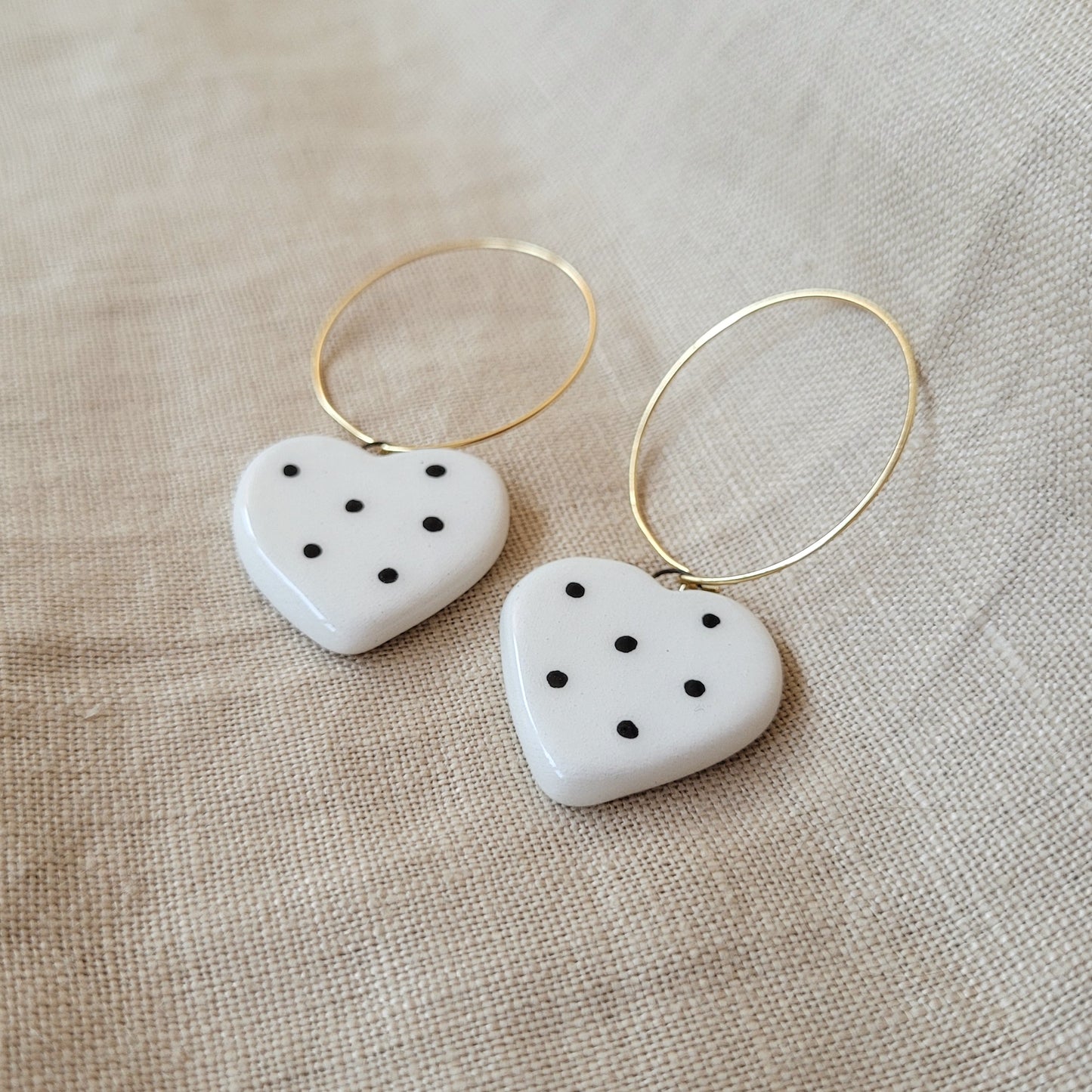 Ceramic dangle earrings "Small white hearts with black dots"