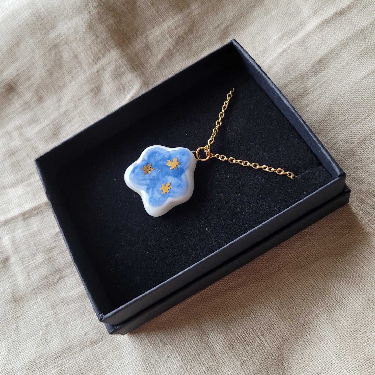 Porcelain necklace with gold "Dark blue cloud with gold stars"