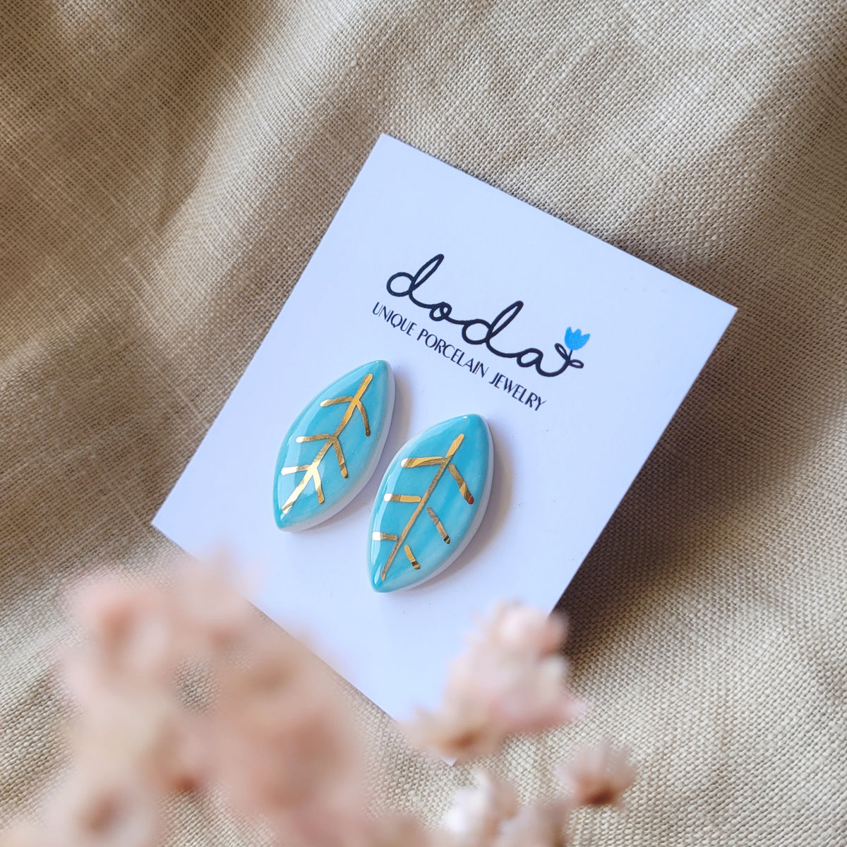Porcelain stud earrings with gold "Light blue leaves"