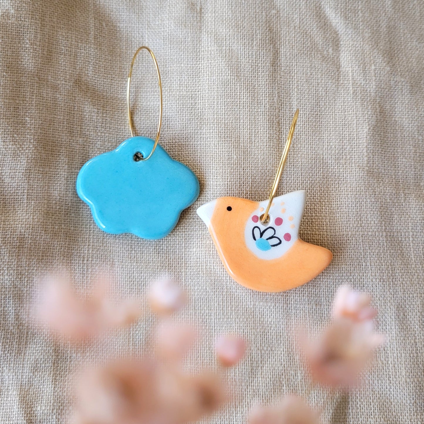 Ceramic mismatched dangle earrings "Orange bird and cloud"