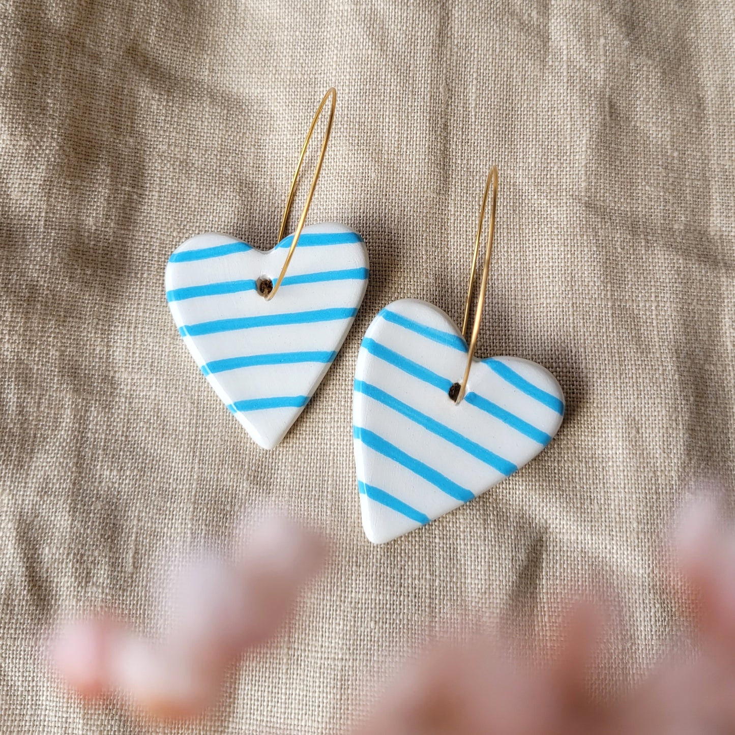 Ceramic dangle earrings "Big white hearts with blue stripes"