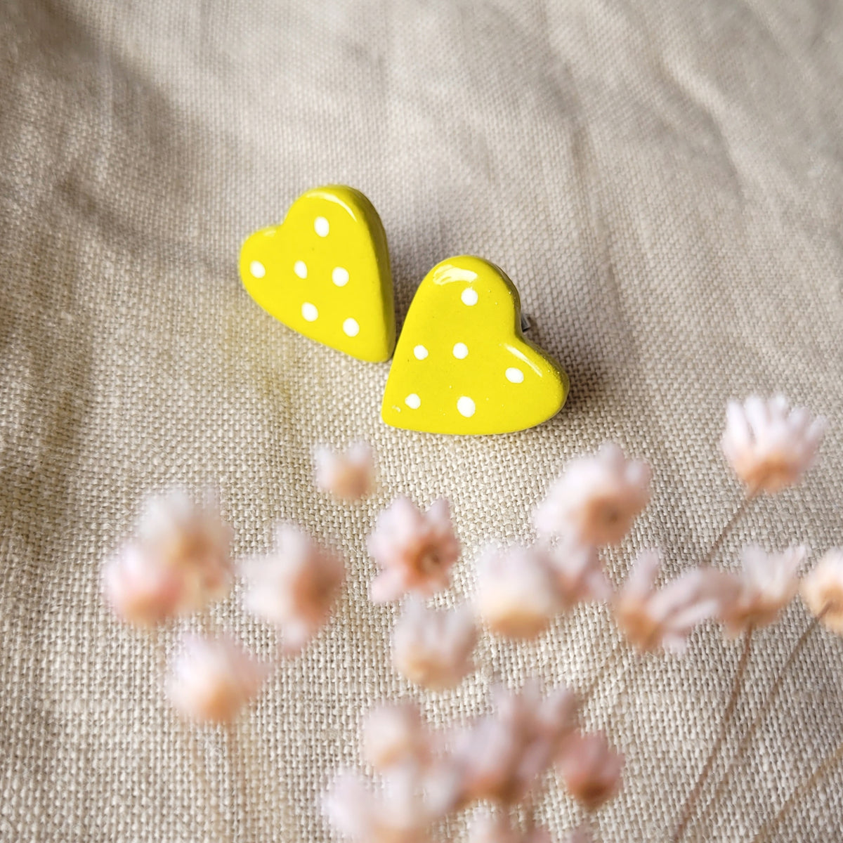 Ceramic stud earrings "Mustard yellow hearts with white dots"