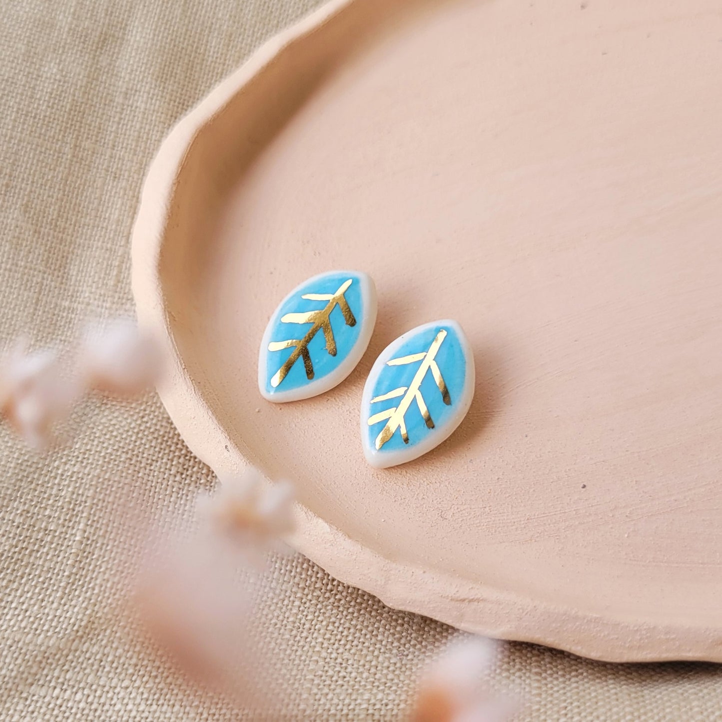 Porcelain stud earrings with gold "Tiny white and blue leaves"