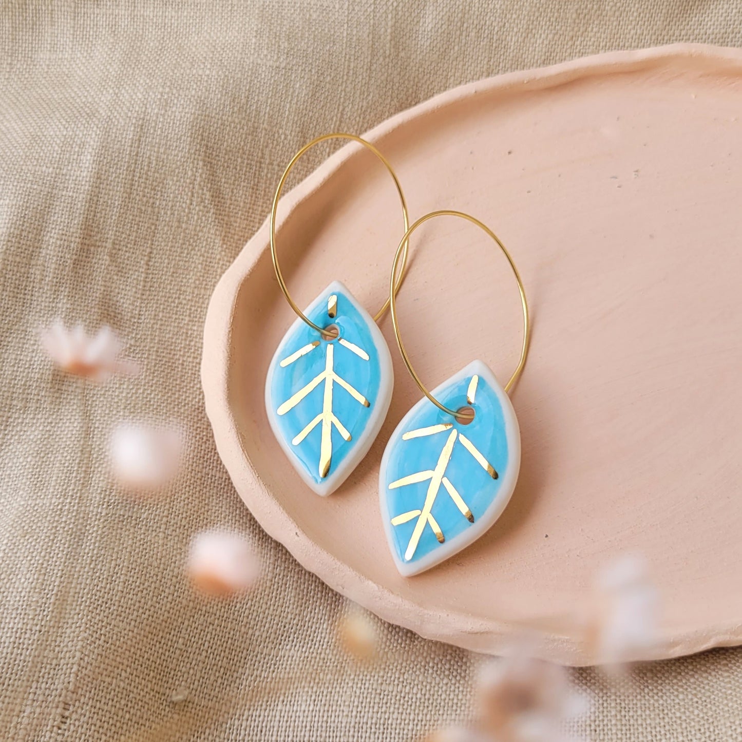 Porcelain dangle earrings with gold "White and light blue leaves"