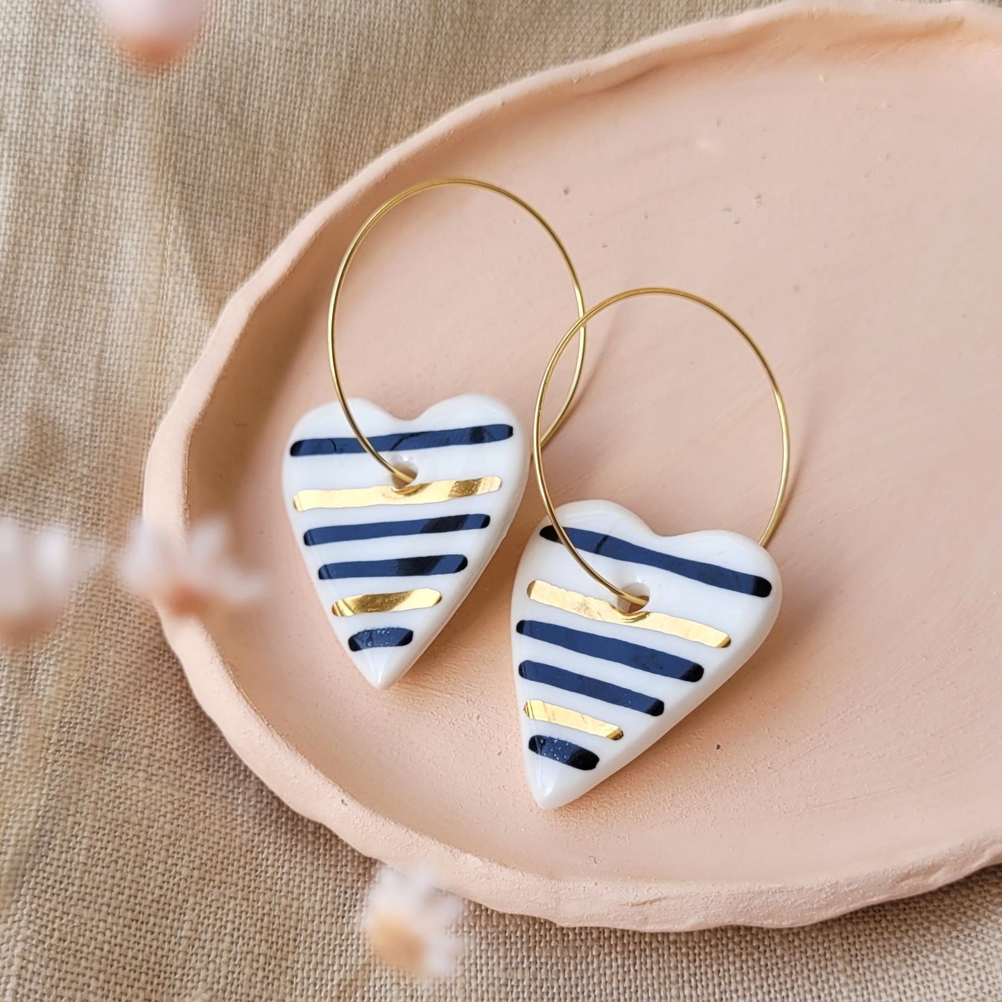 Porcelain dangle earrings with gold "Hearts with black stripes"