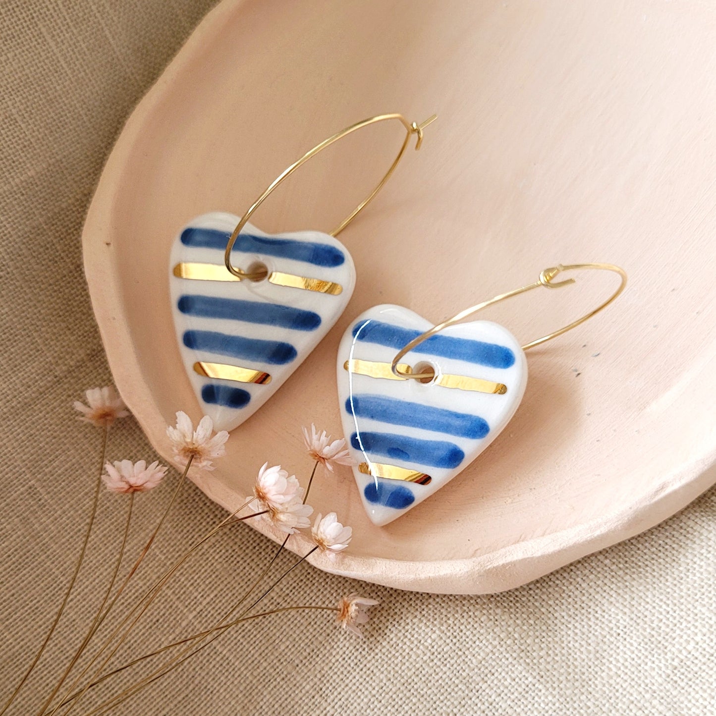 Porcelain dangle earrings with gold "Hearts with blue stripes"