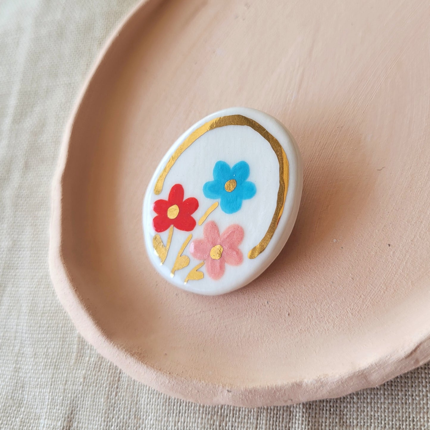 Porcelain brooch with gold "Red, blue and pink"