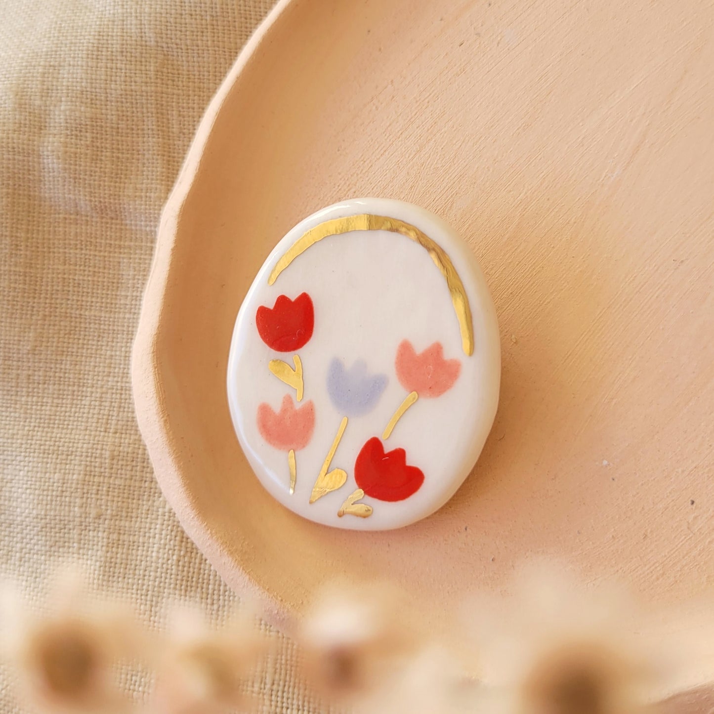 Porcelain brooch with gold "Pink, red and purple tulips"