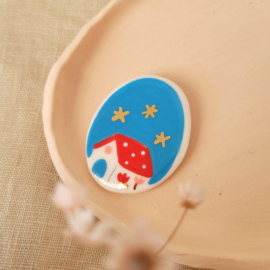 Porcelain brooch with gold "Red house in blue"