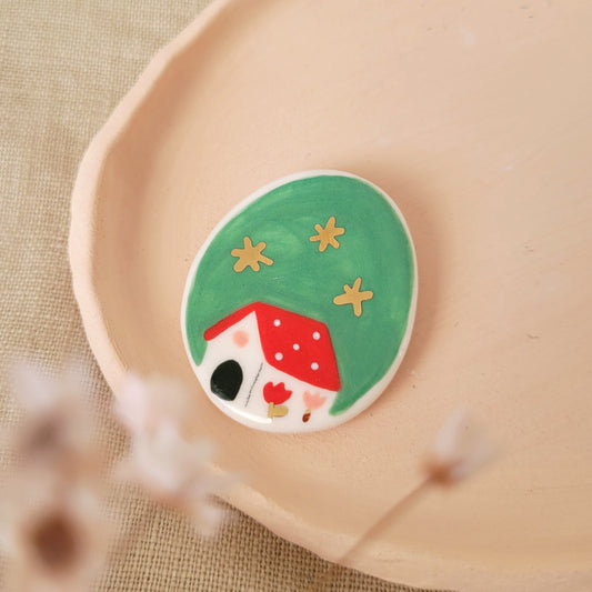 Porcelain brooch with gold "Red house in green"