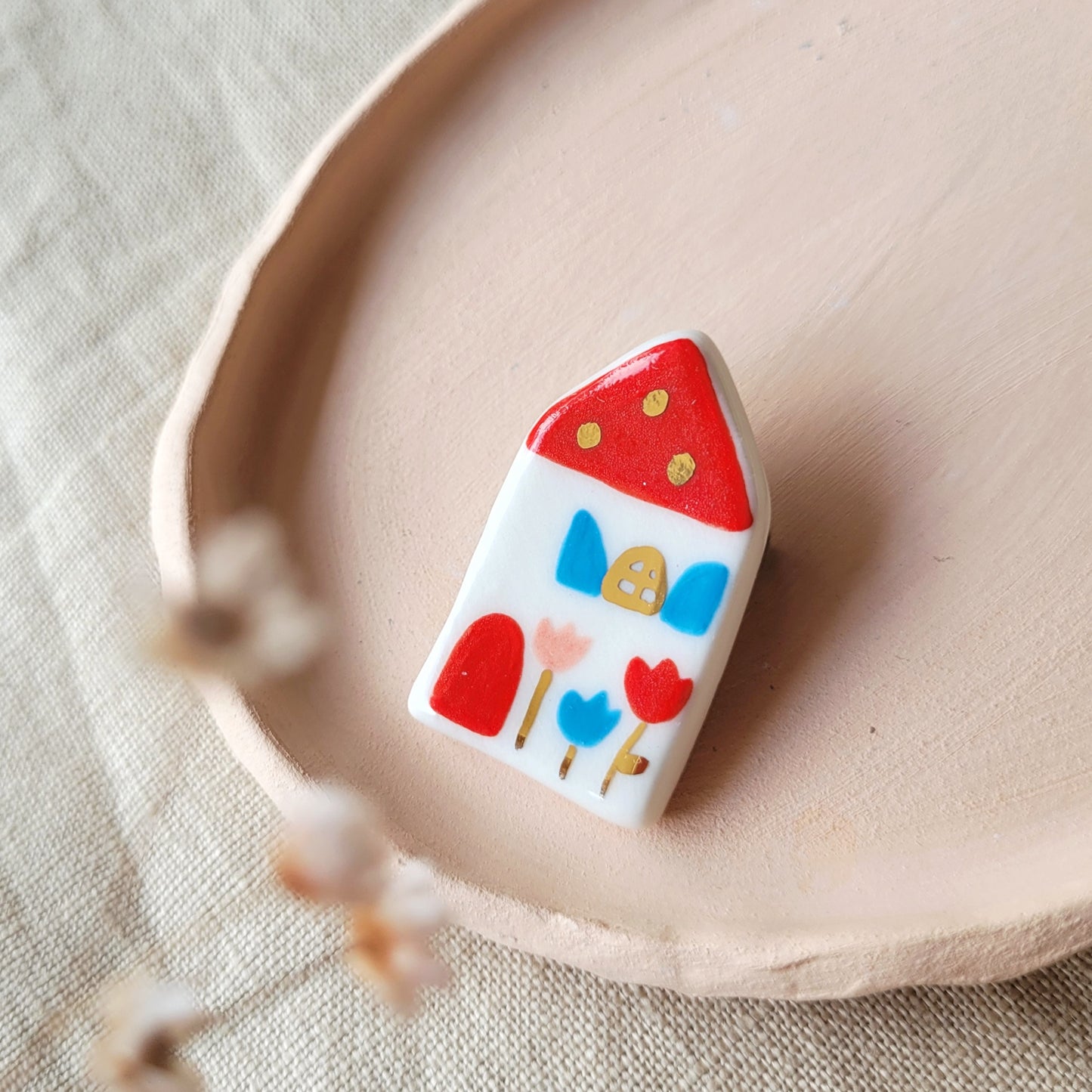 Porcelain brooch with gold "House with red roof"