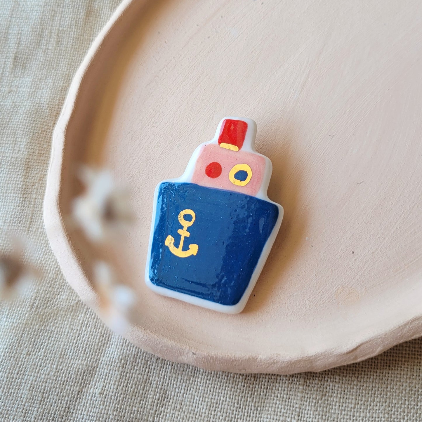 Porcelain brooch with gold "Dark blue boat"
