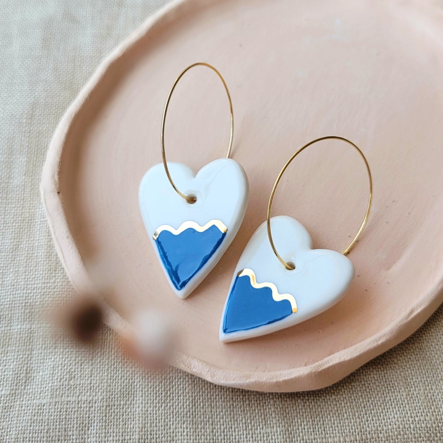Porcelain dangle earrings with gold "Hearts with dark blue waves"