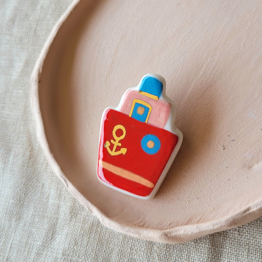 Porcelain brooch with gold "Red boat"