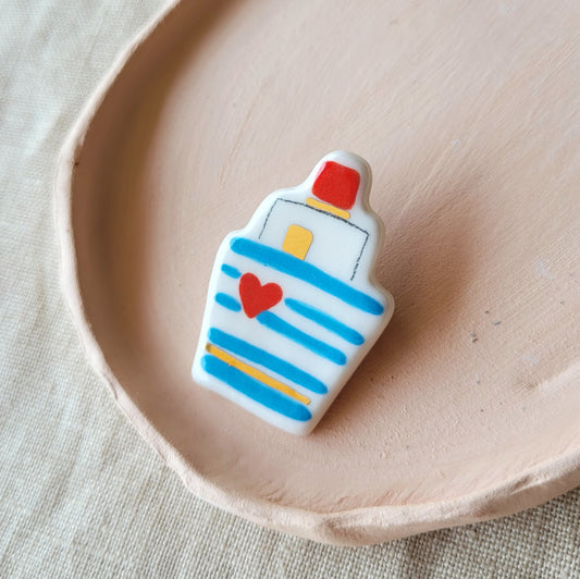 Porcelain brooch with gold "Boat with heart"