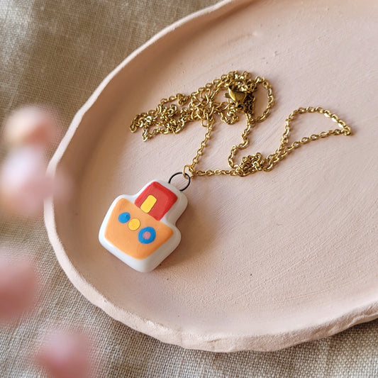 Porcelain necklace with gold "Orange boat"