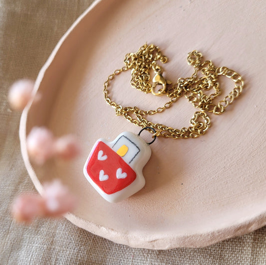 Porcelain necklace with gold "Boat with hearts"