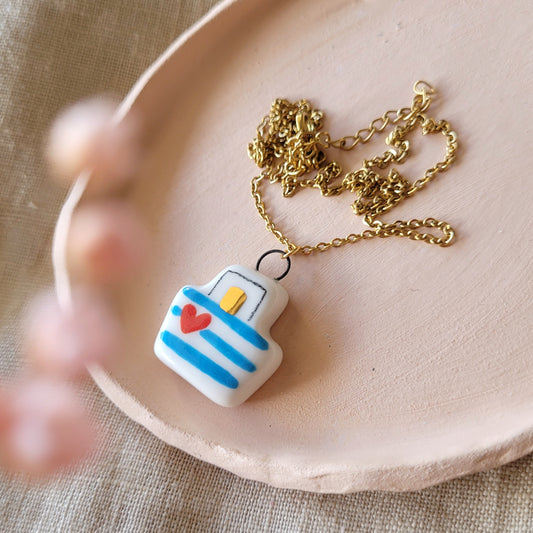 Porcelain necklace with gold "Boat with blue stripes"