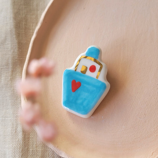 Porcelain brooch with gold "Boat with heart"