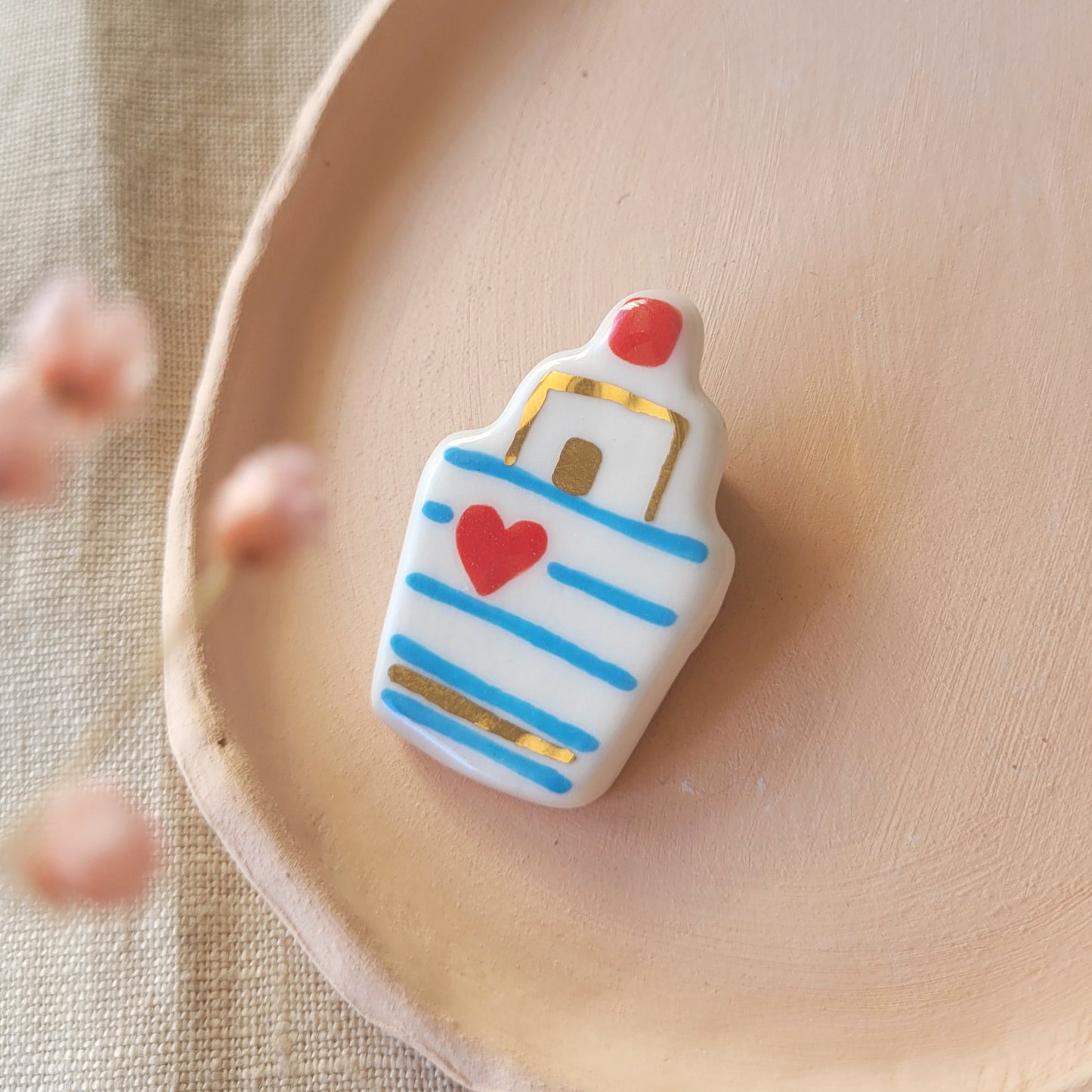 Porcelain brooch with gold "Boat with blue stripes"