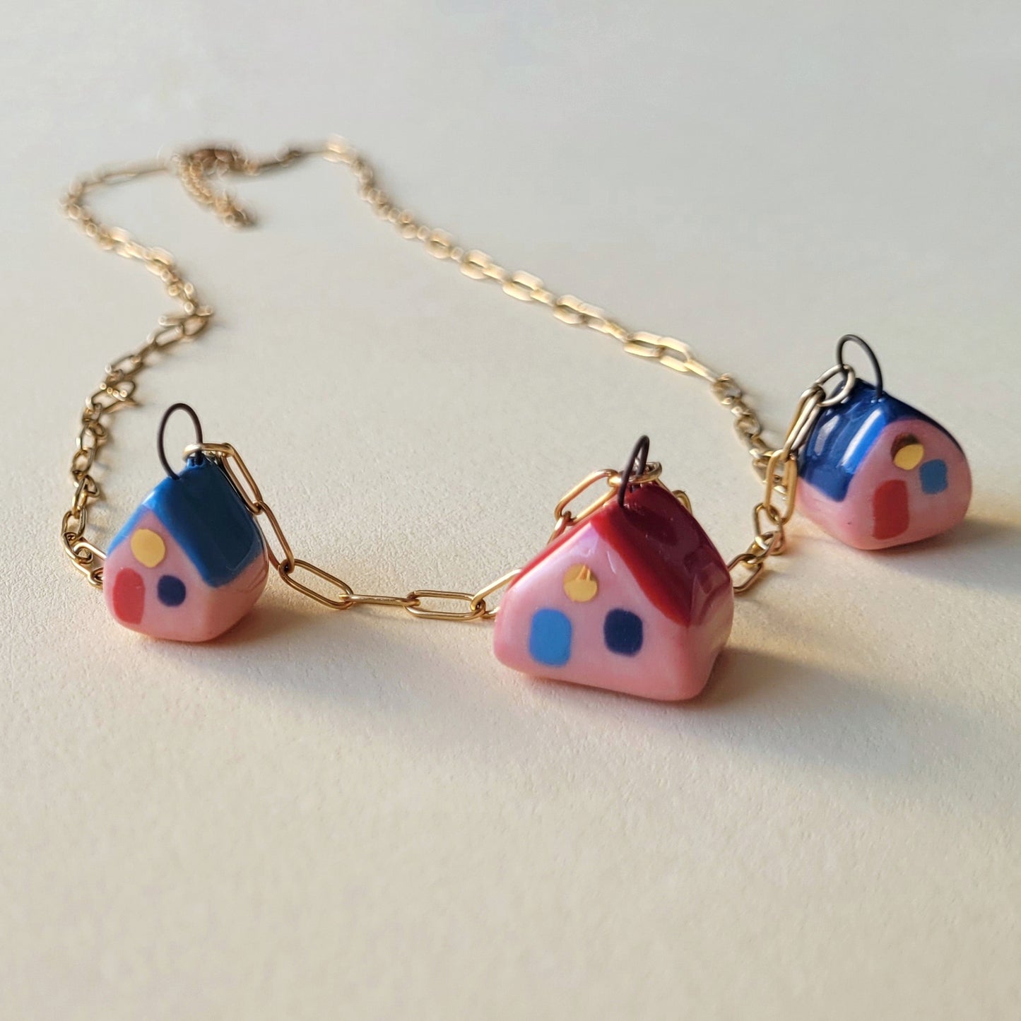 Porcelain necklace with gold "Three houses"