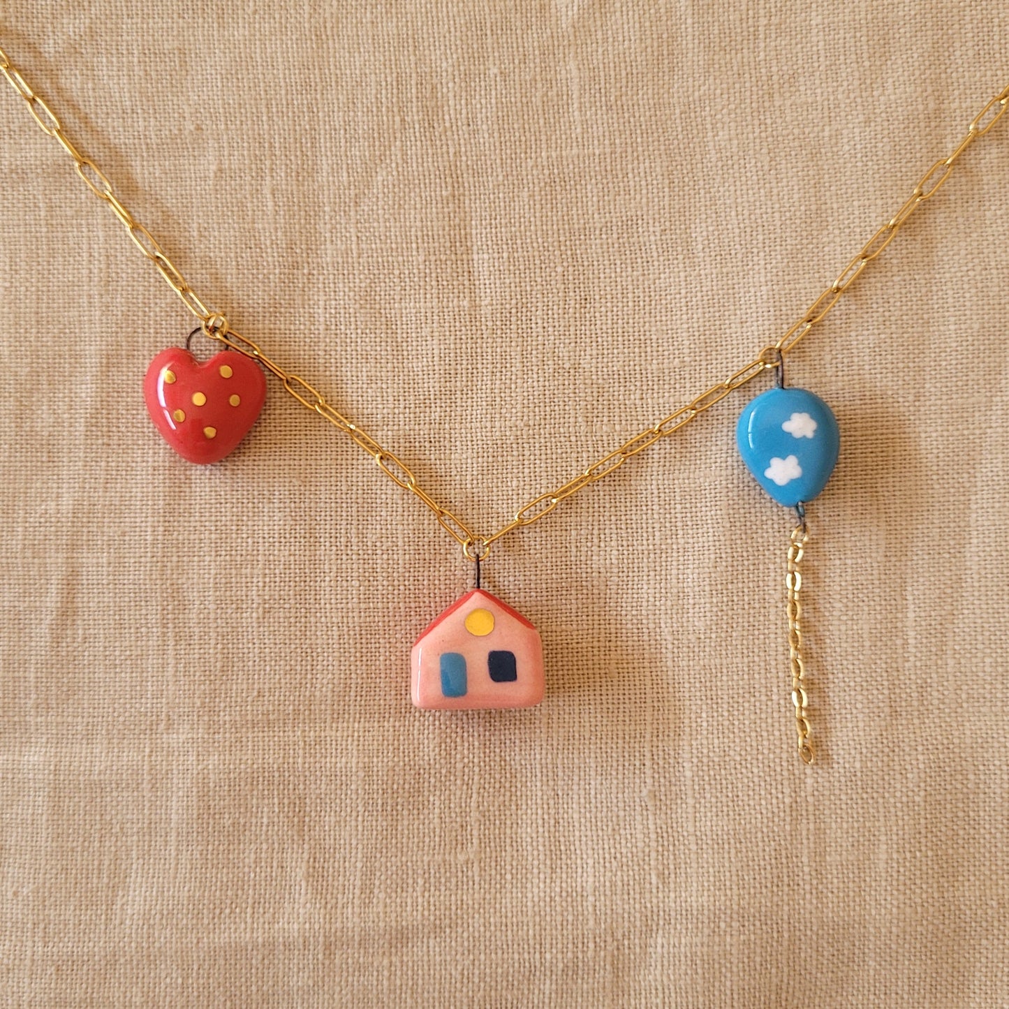 Porcelain necklace with gold "House, heart and balloon"
