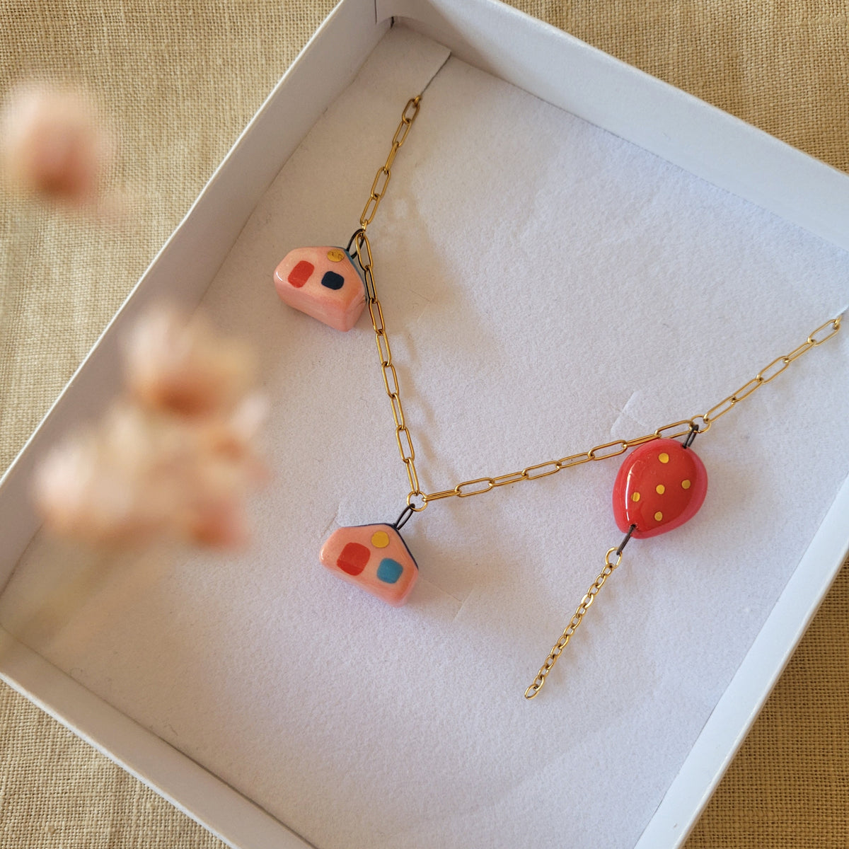 Porcelain necklace with gold "Two houses and red balloon"