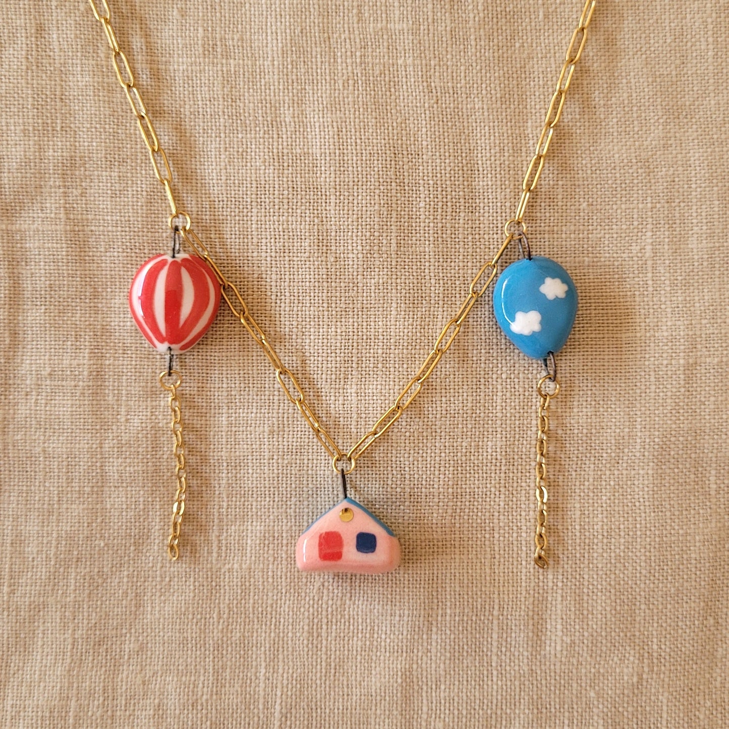 Porcelain necklace with gold "House and two balloons"