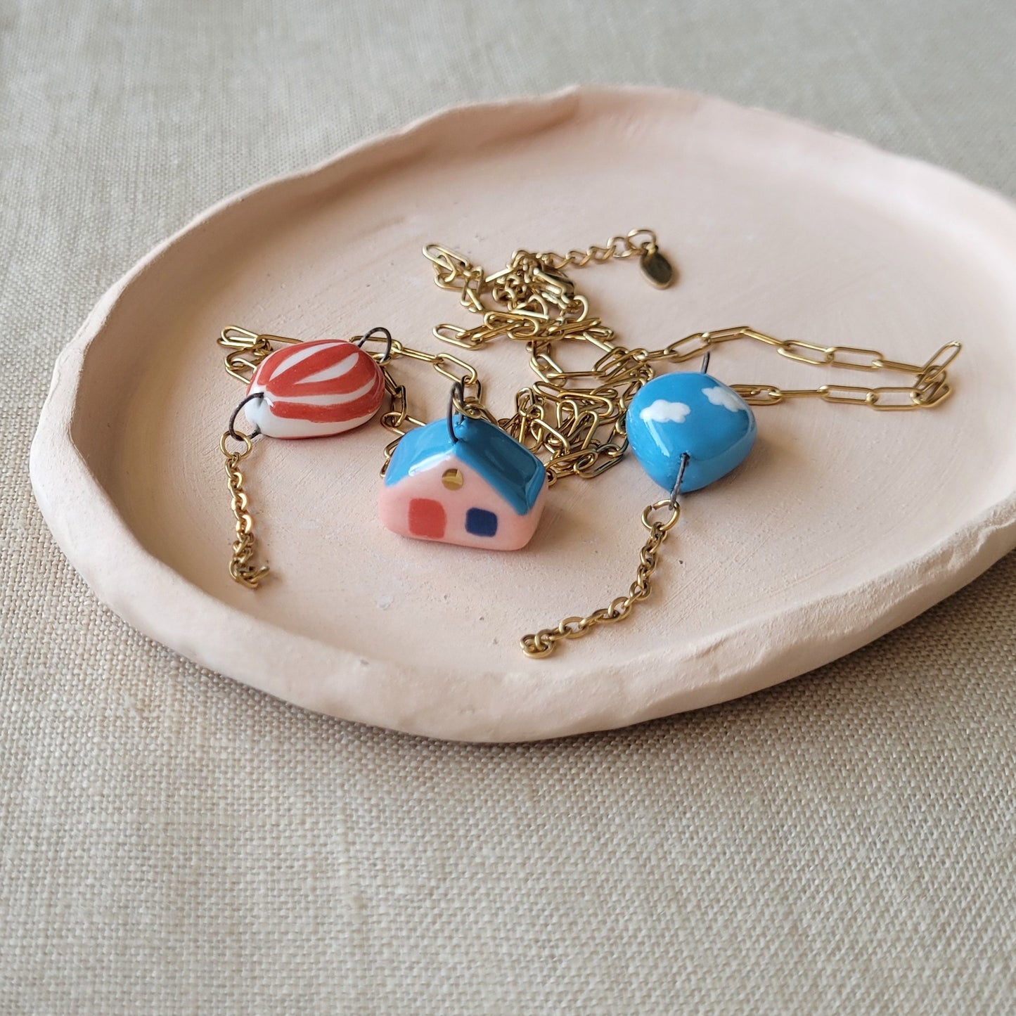 Porcelain necklace with gold "House and two balloons"