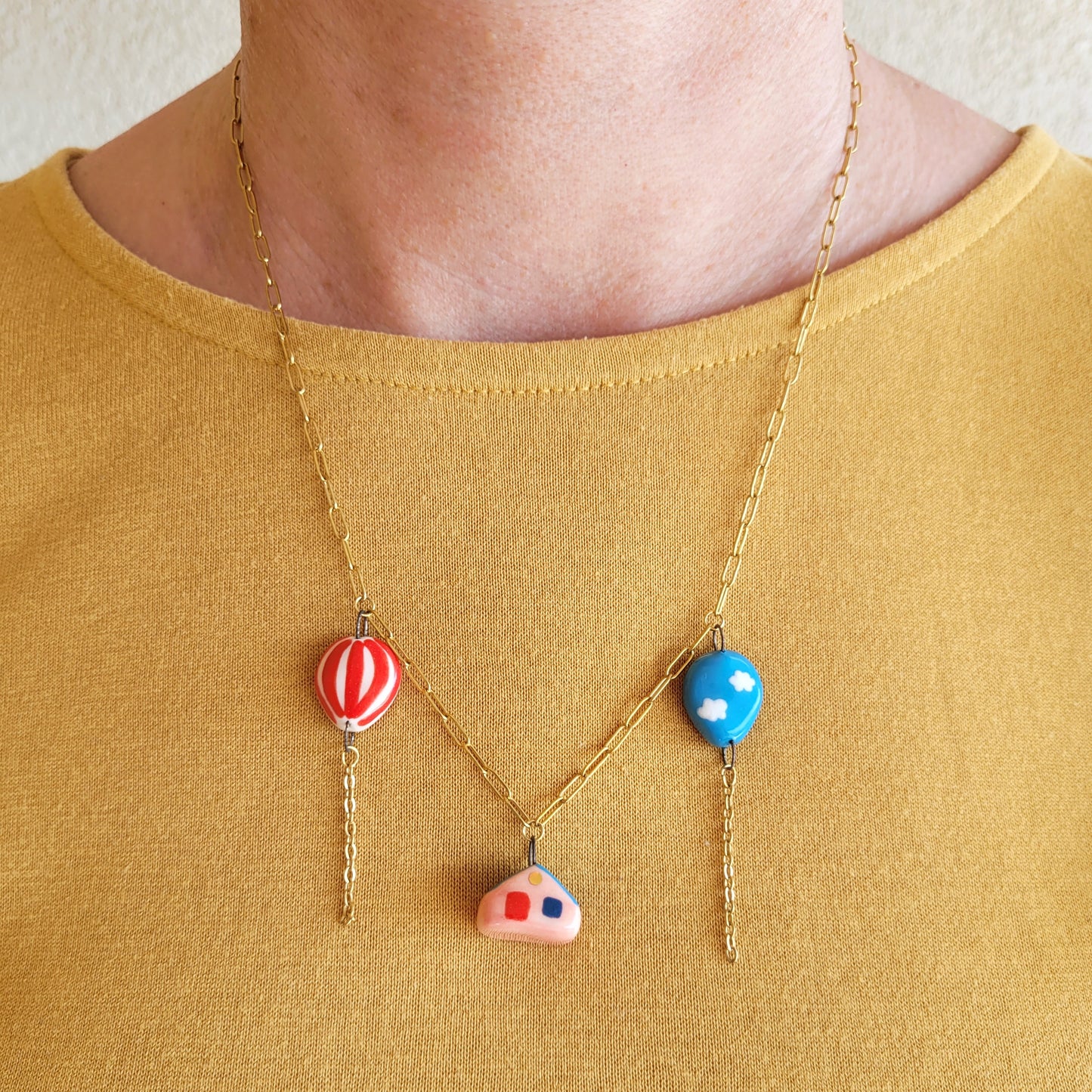 Porcelain necklace with gold "House and two balloons"