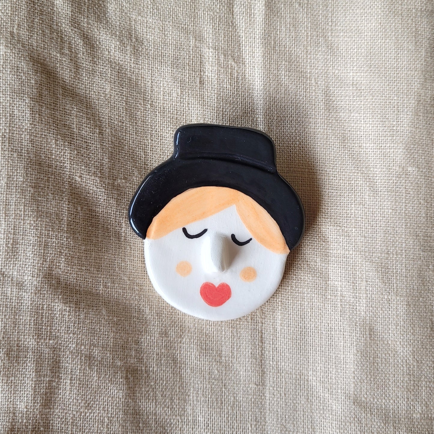 Ceramic brooch "Boy with a black hat"