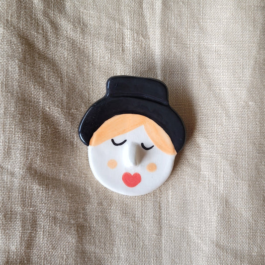 Ceramic brooch "Boy with a black hat"
