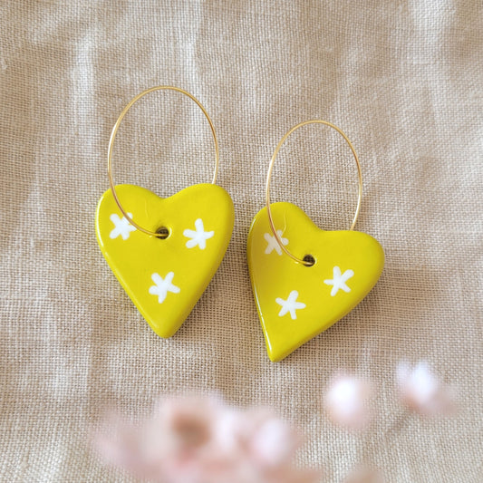 Ceramic dangle earrings "Greenish yellow hearts with white stars"