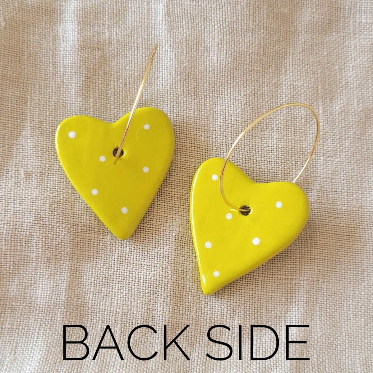 Ceramic dangle earrings "Greenish yellow hearts with white stars"