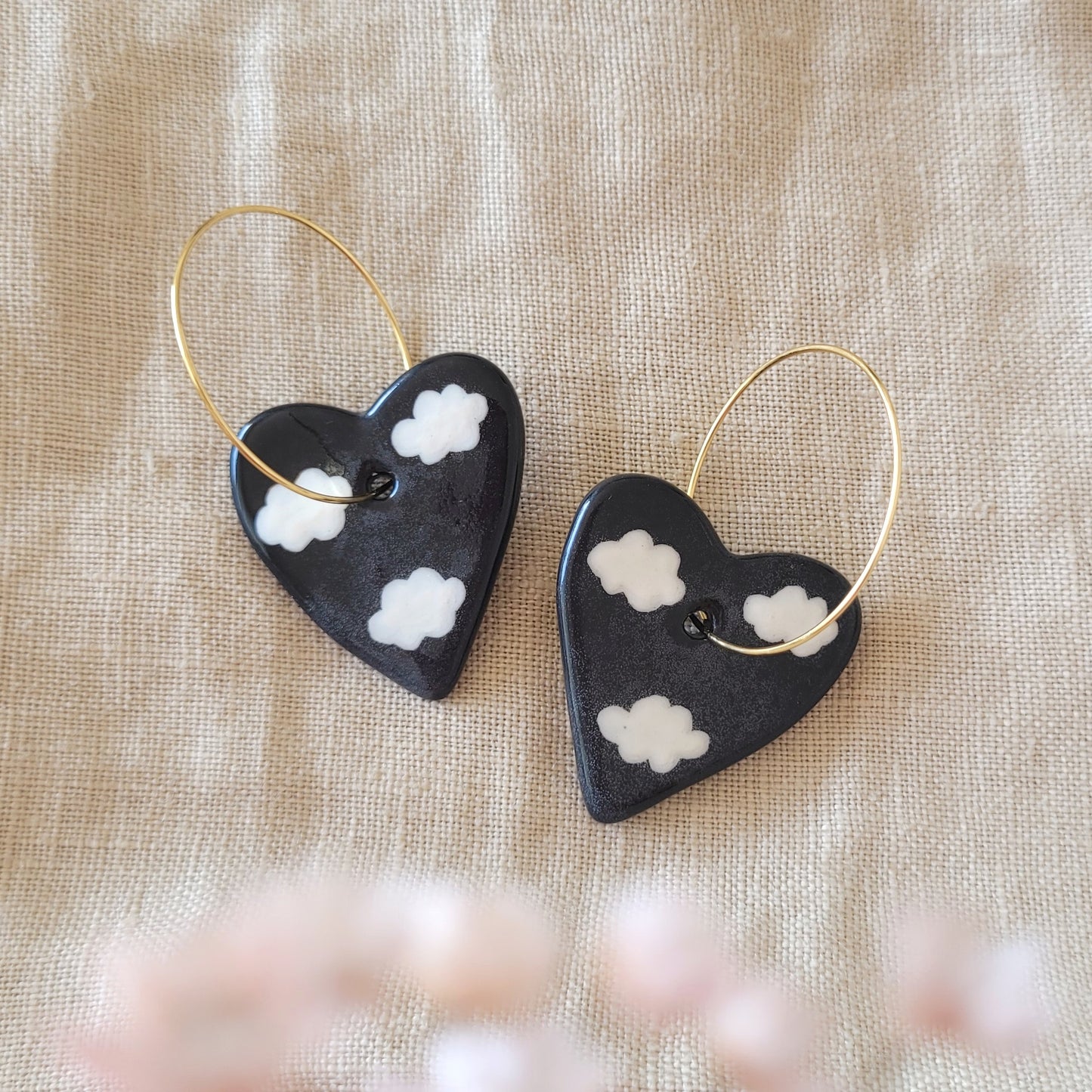 Ceramic dangle earrings "Black hearts with white clouds"