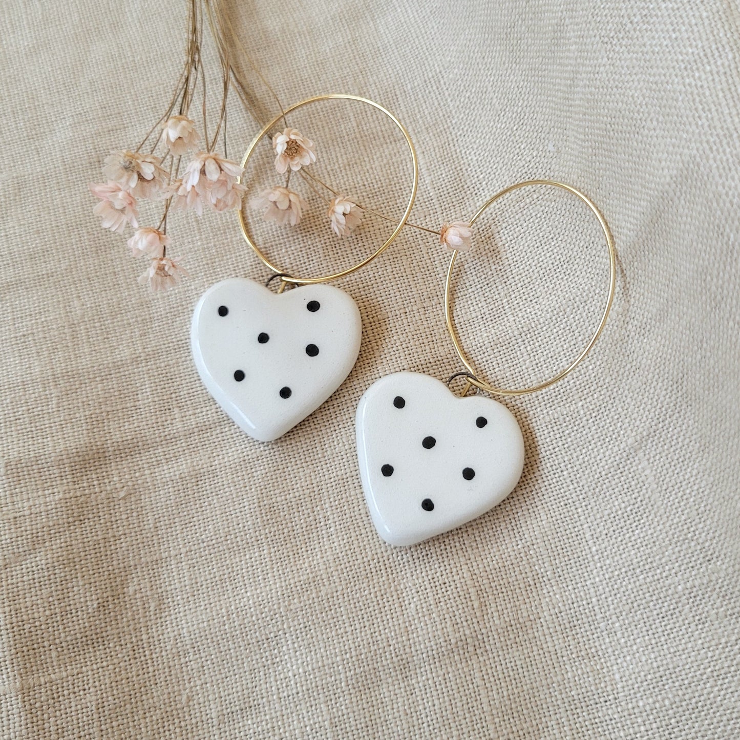 Ceramic dangle earrings "Small white hearts with black dots"