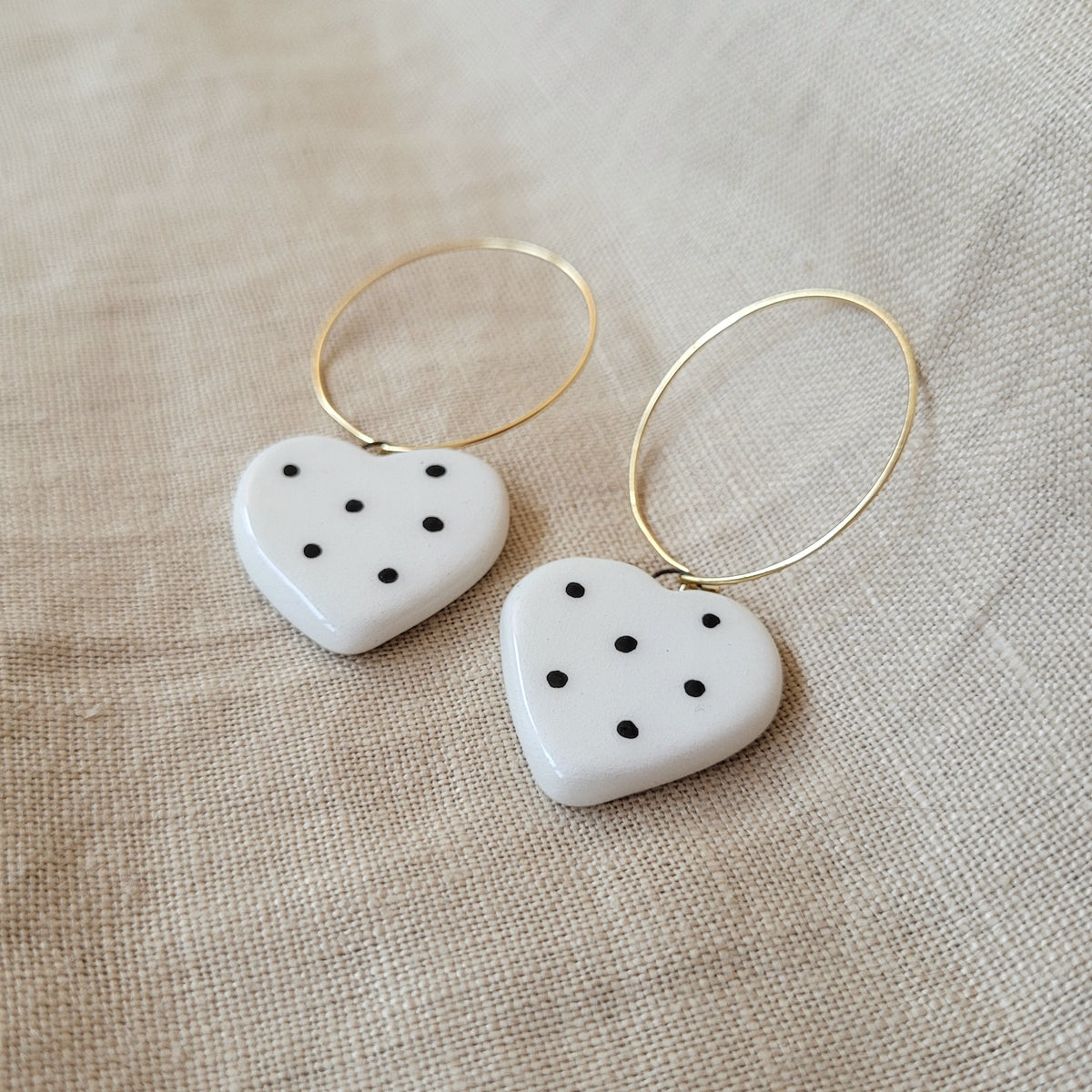 Ceramic dangle earrings "Small white hearts with black dots"