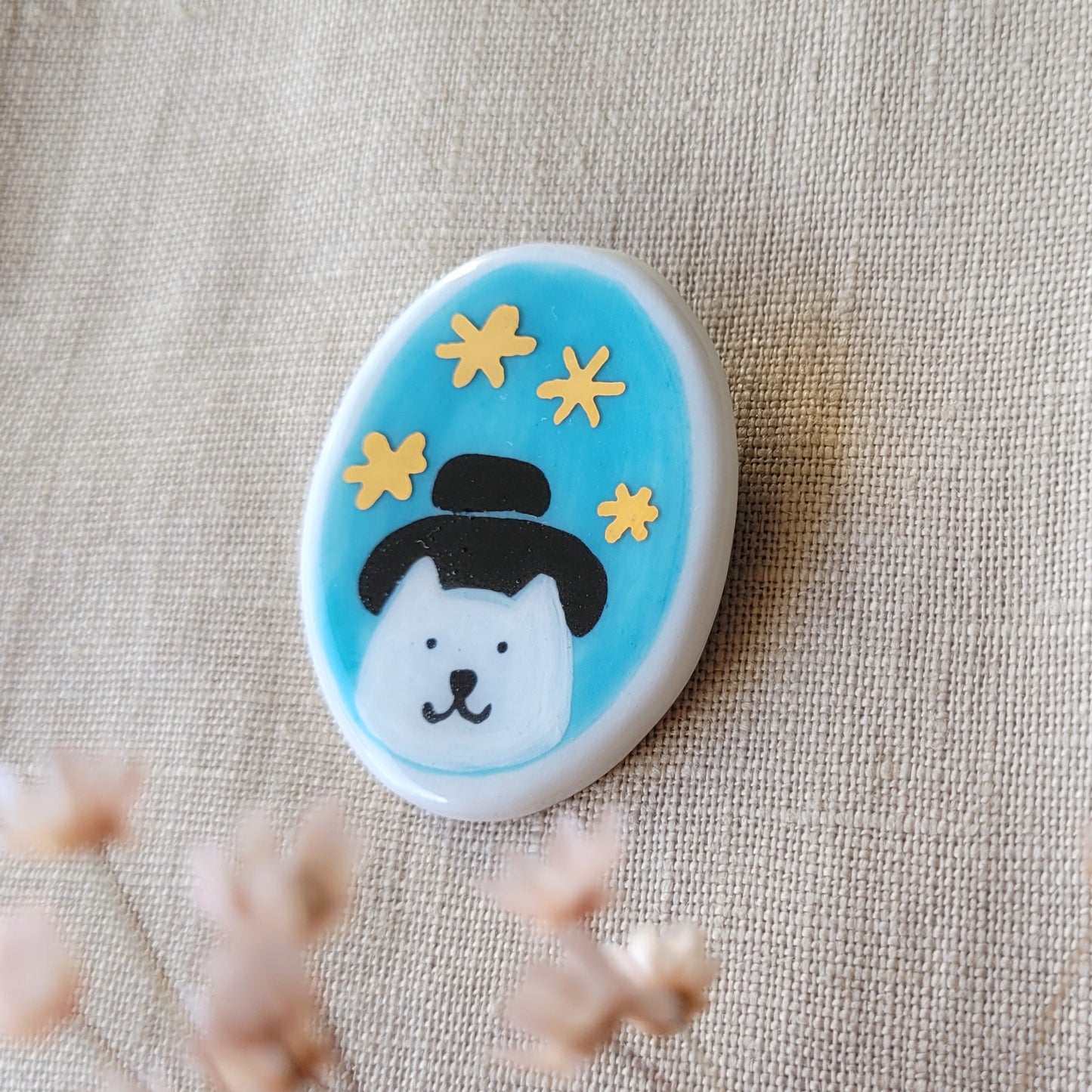 Porcelain brooch with gold "Cat with a hat"