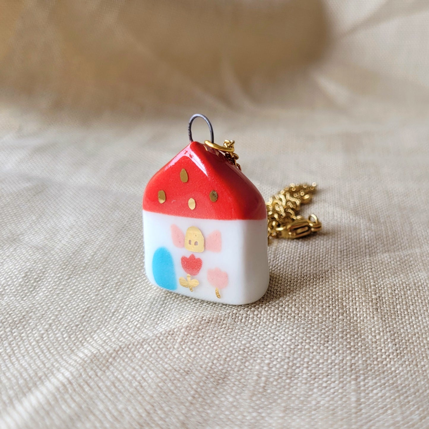 Porcelain necklace with gold "Red house with blue door"