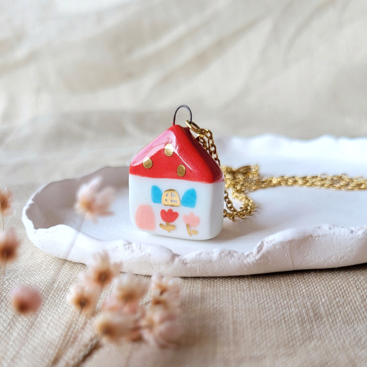 Porcelain necklace with gold "Red house with pink door"