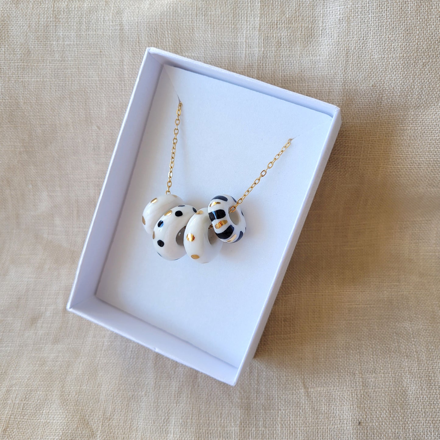 Porcelain necklace with gold "White, black and gold"