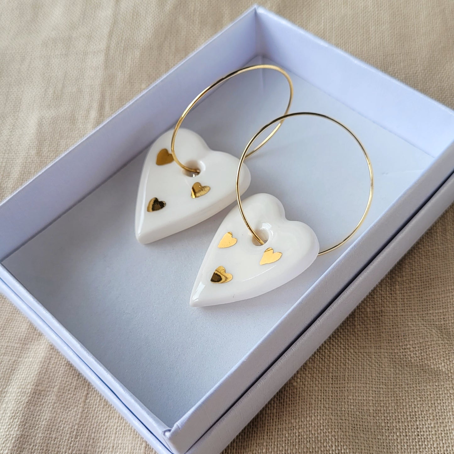 Porcelain dangle earrings with gold "White hearts"