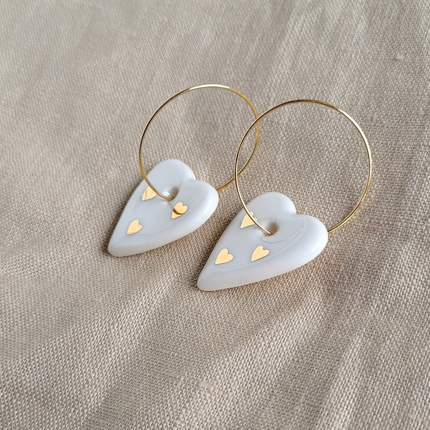 Porcelain dangle earrings with gold "White hearts"